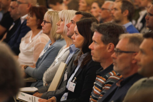 closeup of a row of sitting audience members