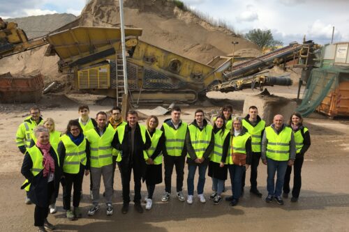 group photo in front of a crusher